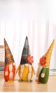 Detailed trio of harvest festival gnomes with maple leaf hats and plaid fabric textures