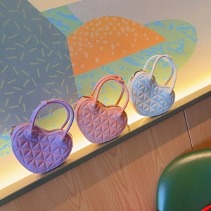 Three heart-shaped PVC jelly mini bags in purple pink and white colors on a stepped display