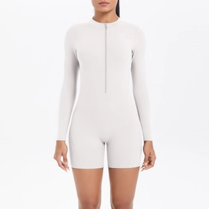 Front view of slim fit long sleeve romper with high neck zipper and ribbed texture