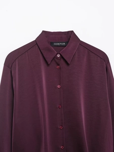 Close-up of deep purple poplin shirt with bead detailing and elegant satin finish