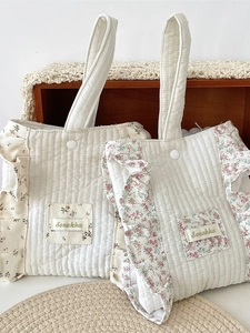 Quilted cotton tote bag with floral ruffled trim and snap closure in cream white