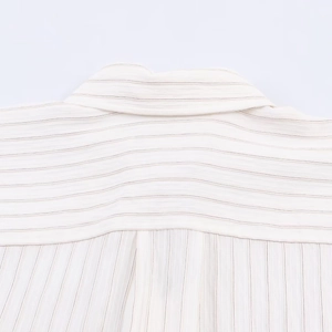 Macro view of fine striped fabric and stitching on the yoke of an off-white shirt