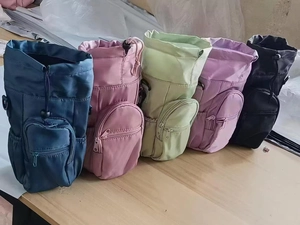 Water bottle bags in navy, pink, green, purple, and black with drawstring and zipper pocket