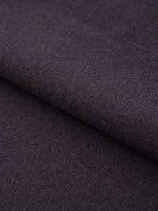 Detailed macro shot of dark purple ribbed knit fabric texture on a long dress