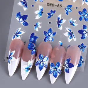 Macro detail of SWO-65 3D embossed nail stickers featuring blue and white floral designs