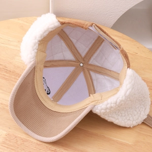 Winter children's trapper hat with brown corduroy and white plush ear flaps for warmth