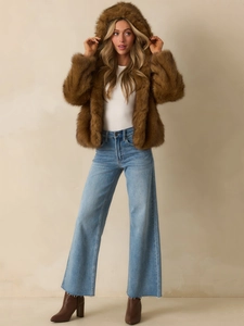 Brown faux fur hooded jacket styled with blue wide-leg jeans and stylish leather boots