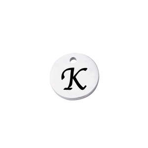 Close-up of polished stainless steel round charm with engraved letter K and top hole