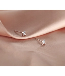 Macro shot of S925 sterling silver four-pointed star stud earrings with tiny zircon stones