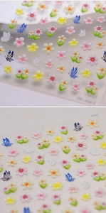Detailed macro view of 3D embossed floral and butterfly nail art stickers model M-581