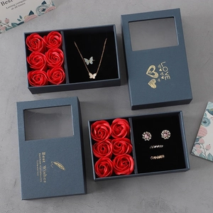 Detail view of blue gift box set with red soap roses and butterfly necklace jewelry storage