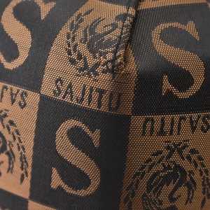 Macro shot of plaid checkered fabric texture and brand logo detail on baseball cap