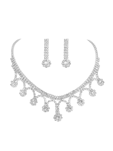 Detailed view of luxury silver tassel necklace and drop earrings with sparkling rhinestones