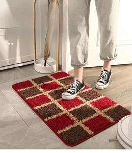 Detail of red and brown checkered entryway rug with durable dust-removal fiber texture