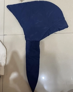 Detail view of deep blue padded windproof hood featuring a long strap for winter protection