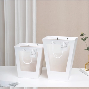 White trapezoid gift bags with clear window and Tomorrow is another day tag