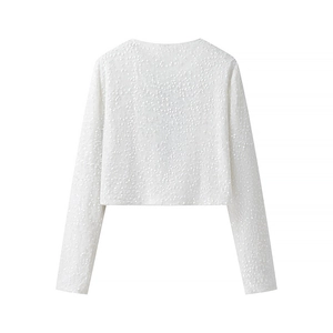 Detailed view of white sequined crop top cardigan with long sleeves and round neck