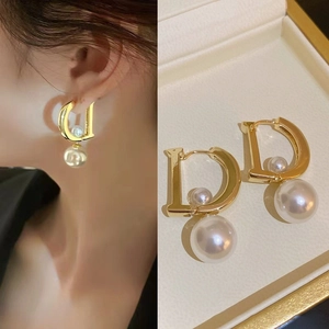Golden D-shaped hoop earrings with white pearls and elegant zircon accents for women
