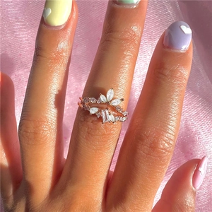 Close-up of rose gold silver floral ring set with marquise and pear cut stones on hand