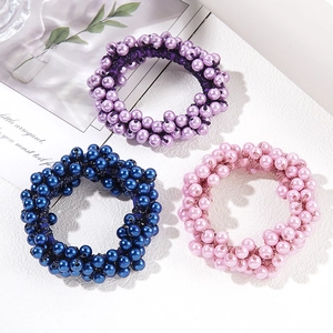 Three elegant pearl beaded elastic hair ties in purple, dark blue, and pink colors