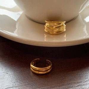 Close-up of golden S925 sterling silver double-layer ring with textured ripple design