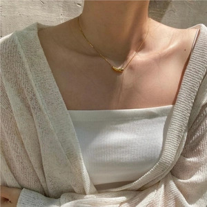 Elegant 925 sterling silver gold teardrop necklace on model with a knit cardigan