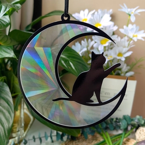 Detailed view of suncatcher showing a black cat silhouette on a holographic moon prism