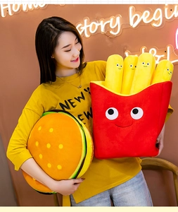 Smiling model holding soft plush hamburger and french fries pillows in vibrant colors