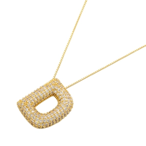 Macro shot of 18K gold plated letter D pendant fully encrusted with white cubic zirconia