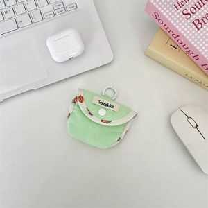 Close-up of light green fabric earphone case with floral trim and white clip hook