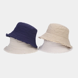 Detail of multi-color cotton canvas bucket hats featuring frayed edges and plain texture