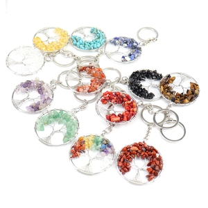 Detailed flat lay of Tree of Life keychains with colorful natural crystal stone chips