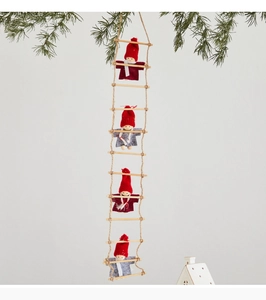 Detail of four festive Santa dolls on a rope ladder with soft felt and wood textures