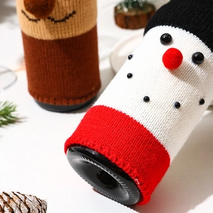 Festive knitted Christmas wine bottle cover featuring a cute white snowman design