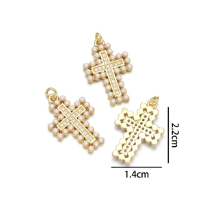Detailed view of three gold cross pendants with pearls and zircons, size 2.2cm by 1.4cm