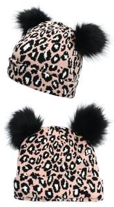 Close-up of pink leopard knit beanie featuring double black faux fur pom-poms on the top
