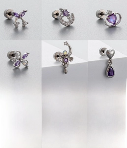 Detailed views of silver surgical steel ear studs featuring purple cubic zirconia inlays
