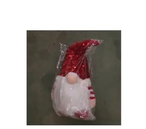 Standard packaging detail of a light-up Christmas gnome plush toy with red sequins