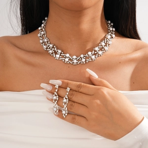 Detail of silver layered floral necklace and earrings set with rhinestones and pearls
