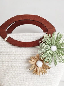 Bohemian woven cotton rope tote bag with wooden handles and floral accents in beige