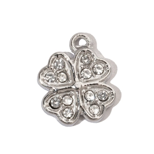 Macro shot of silver four-leaf clover pendant with heart-shaped leaves and white zircons