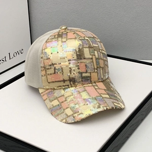 Detail of colorful geometric sequins on curved brim of a breathable mesh baseball cap