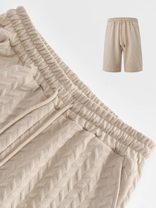 Detail of men's beige casual shorts featuring textured herringbone fabric and drawstring waist