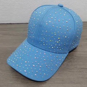 Close-up of sparkling colorful rhinestones on a sky blue cotton baseball cap surface