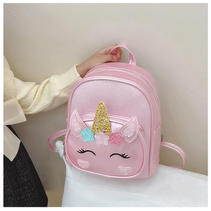 Detail of pink unicorn backpack with glitter finish and decorative horn for girls