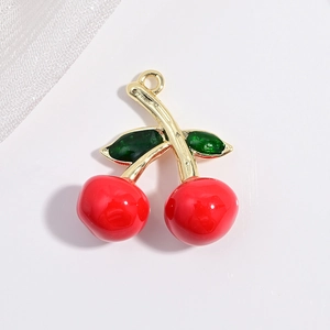 Detailed close-up of a red cherry fruit pendant with golden stem and green leaves