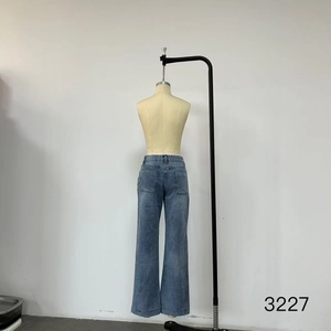Rear view of vintage high-waist denim pants with back pockets and washed texture
