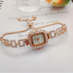 Detail of rose gold square watch with crystal accents and adjustable slider bracelet