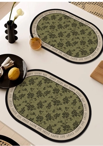 Macro shot of olive green leather placemat with floral pattern and decorative border