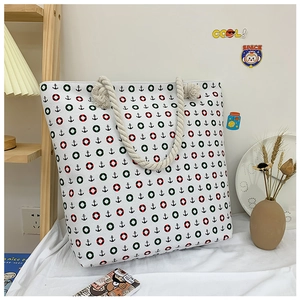 Canvas tote bag with anchor print and thick rope handles in a cozy home setting